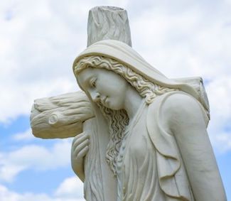 Mary Magdalene statue, holding onto the cross